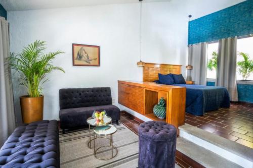 a living room with a bed and a tv at New Family Home with Pool Jacuzzi & Fronton in Cuernavaca