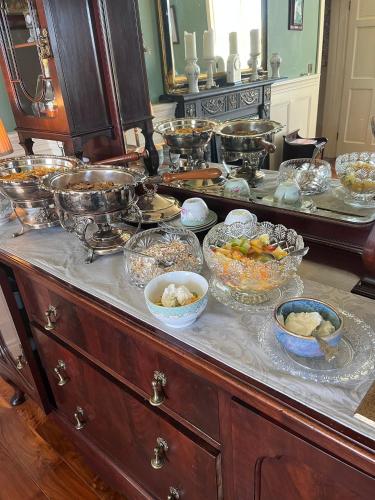 a buffet with many bowls of food on it at Bealkelly Country House in Killaloe