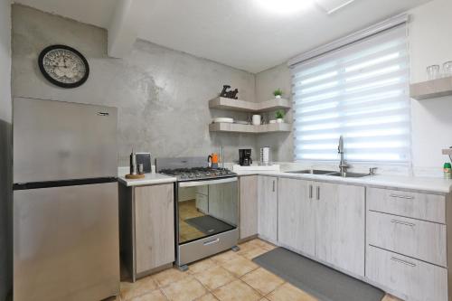 a kitchen with a sink and a stove top oven at Casa Lula Beach Retreat - Dog friendly, Fenced backyard in Arecibo