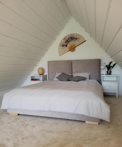 a bedroom with a large bed in a attic at Chochołowska Przystań in Chochołów