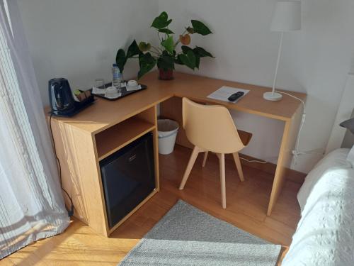 a wooden desk with a chair next to a bed at Quinta Salinas - Puro Prazer in Aveiro