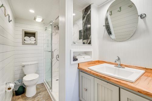 a bathroom with a toilet sink and a mirror at Beachfront Panama City Condo with Balcony and Views! in Panama City