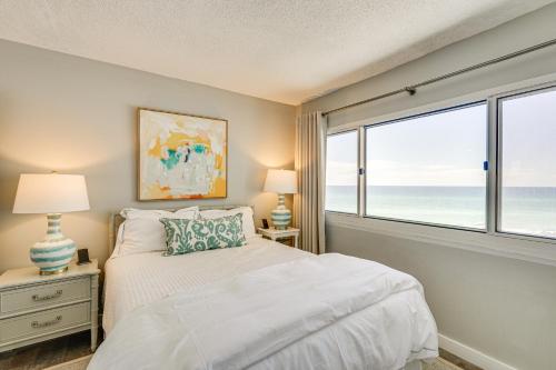 a bedroom with a bed and a large window at Beachfront Panama City Condo with Balcony and Views! in Panama City