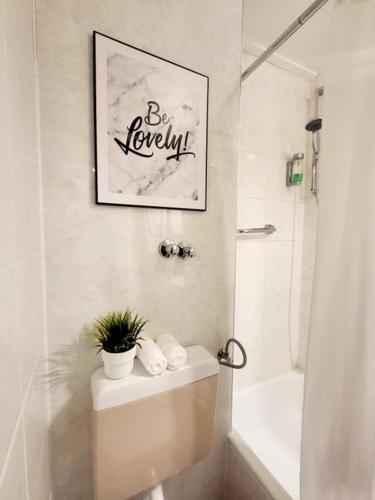 a bathroom with a toilet with a plant on it at Apartment mit Rheinblick Koblenz in Koblenz