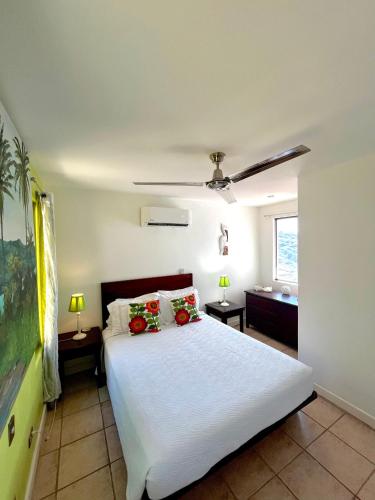 a bedroom with a white bed with red flowers on it at LoneStar Tico in Sardinal