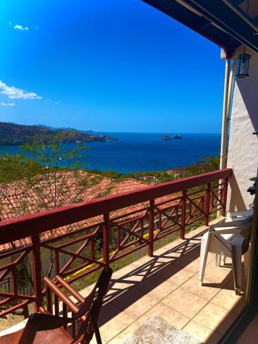 a balcony with a view of the ocean at LoneStar Tico in Sardinal