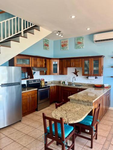 a large kitchen with a table and a refrigerator at LoneStar Tico in Sardinal