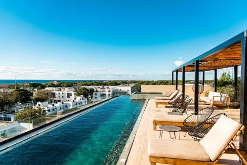 a swimming pool on the roof of a house at Studio 2 blks 5th beach shops ac in Playa del Carmen