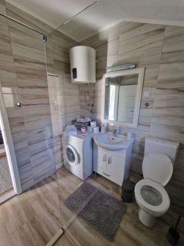 a bathroom with a toilet and a sink and a shower at Studio apartmani Milović in Trebinje