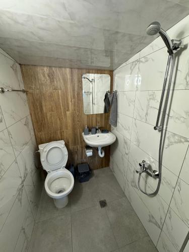 a small bathroom with a toilet and a sink at Villa Raiski kyt in Dospat