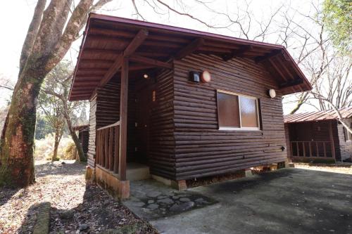 a log cabin with a porch and a tree at Toso Youth Travel Village - Vacation STAY 30483v 