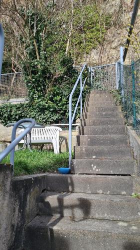 a set of stairs with a white park bench at Schwabenstuben Einzelzimmer in Meersburg