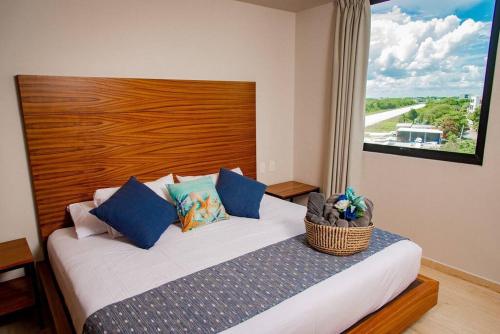 a bedroom with a bed with a wooden head board at 2BED 3BATH 2 blks 5th beach shop in Playa del Carmen