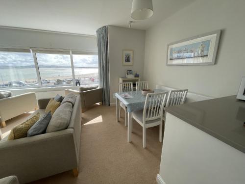 - un salon avec un canapé et une table dans l'établissement Lovely seafront 2 bedroom Apartment 4, à Aberdyfi