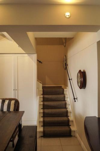a staircase in a house with a table at Logis König in Swakopmund