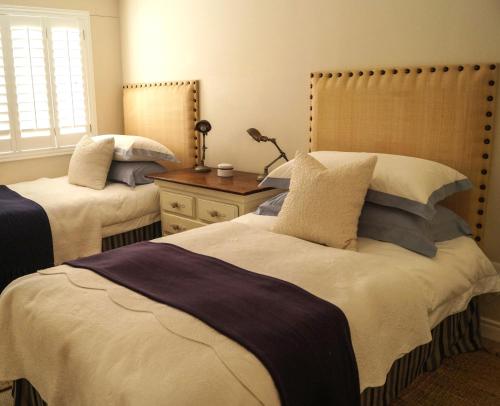 a bedroom with two beds with pillows at Logis König in Swakopmund