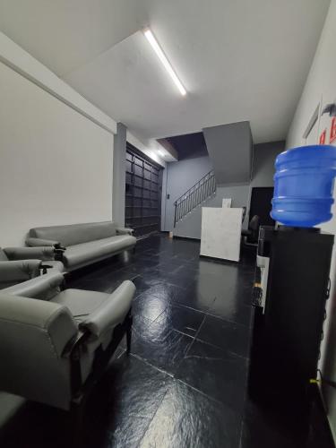 a room with couches and chairs in a room at Villa Fátima Hostel GRU in Guarulhos