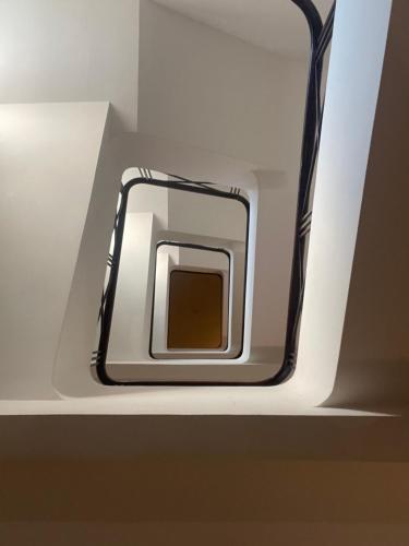 a cell phone is sitting on a shelf at Castelar Hotel Santa Fe in Santa Fe