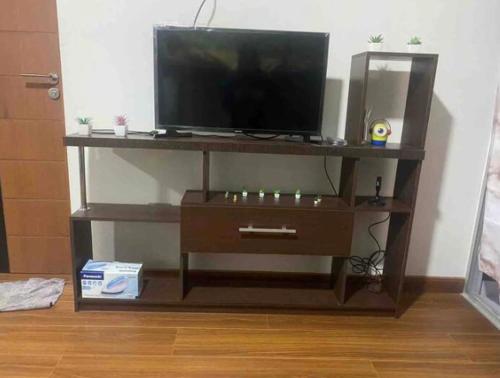 a entertainment center with a flat screen tv on top at Hermoso Garzonier in Cochabamba