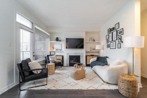 a living room with two chairs and a fireplace at Luxury Urban Town home in Oakville