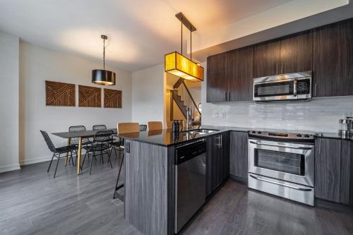 a kitchen and dining room with a table with chairs at Luxury Urban Town home in Oakville
