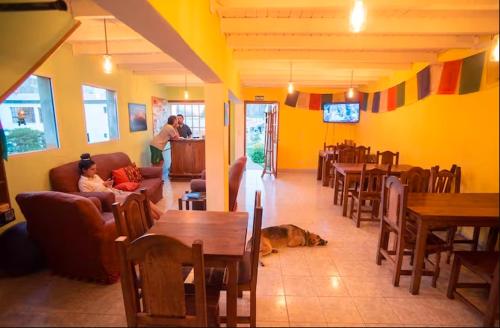 a living room with a dog laying on the floor at Hostel Wenuy- in El Chalten
