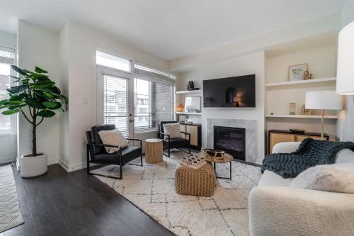 a living room with a couch and a fireplace at Luxury Urban Town home in Oakville