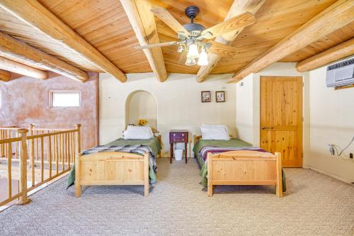 a bedroom with two beds and a wooden ceiling at Adobe St David Vacation Rental Near River! 