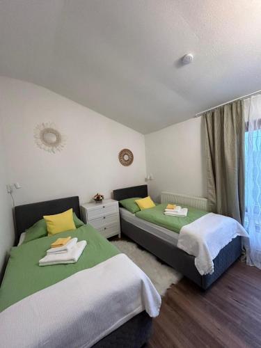 a bedroom with two beds and a window at Cazare La Luiza b in Şura Mare