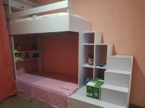 a white bunk bed in a room with a box at Villa Vielet Lalovina in Mahajanga
