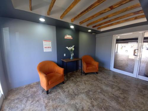 a waiting room with two chairs and a table at Hotel Rose Ensenada in Ensenada