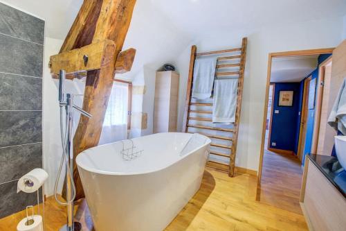 a bathroom with a large white tub in a room at l'Escarpediem : Évasion Pittoresque in Meyrals