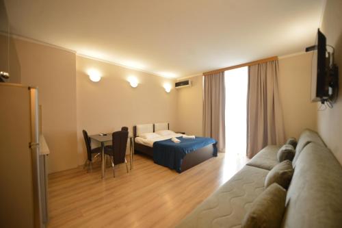 a living room with a couch and a table at BATUMi WELLCOME ORBI APART HOTEL in Angisa