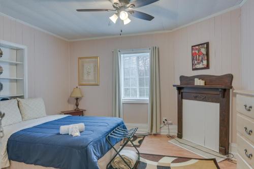 a bedroom with a blue bed and a fireplace at Charming Fayetteville Home with Deck and Grill! in Fayetteville