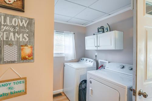 a small laundry room with a washer and dryer at Charming Fayetteville Home with Deck and Grill! in Fayetteville