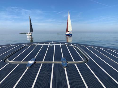 two sailboats in the water on a dock with a boat at Ecolodge Almere in Almere