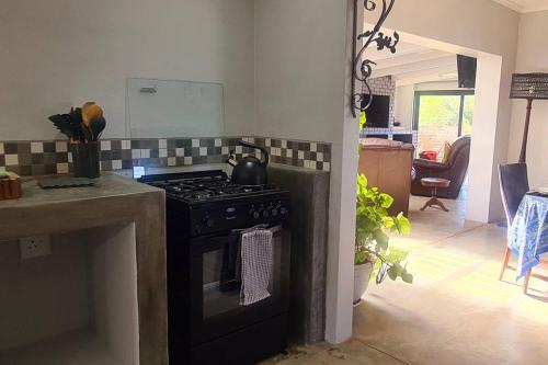 a kitchen with a stove top oven in a room at The Farmstead in Cannon Rocks