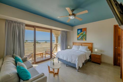 a bedroom with a bed and a view of the beach at Gran Pacifica Beach Resort & Homes in San Diego