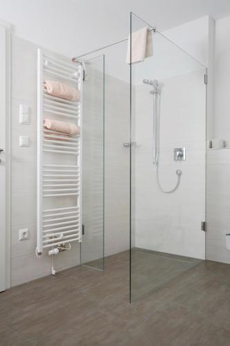a bathroom with a glass shower stall with towels at Ferienhaus Dickertsmühle in Prien am Chiemsee