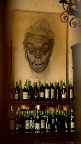 a bunch of bottles of wine on a shelf at Hotel Posada la Ermita in San Miguel de Allende