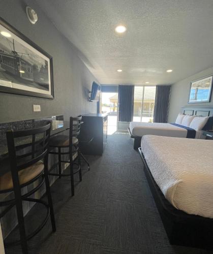 a hotel room with two beds and a bar at Interstate Inn in Roland