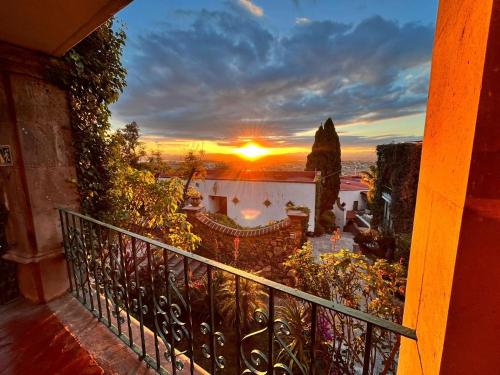 a sunset seen from a balcony of a house at Hotel Posada la Ermita in San Miguel de Allende