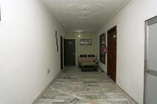 an empty hallway with a chair in a room at OYO Hotel Blue Moon in Hisār