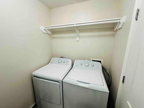 a small laundry room with a washer at Sharyland Townhome in McAllen