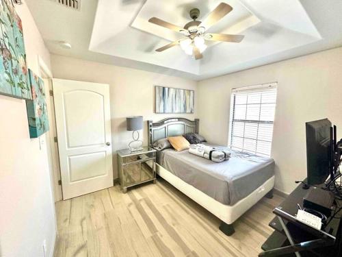 a bedroom with a bed and a ceiling fan at Sharyland Townhome in McAllen