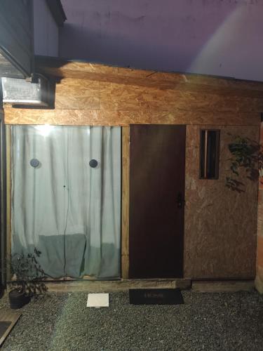 a building with a glass door in a room at Small house in Itajaí