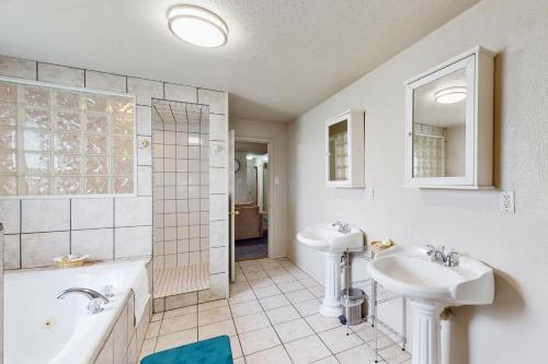 a bathroom with a tub and a sink and a bath tub at Quinlan Ranch in Quinlan