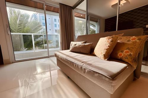 sala de estar con sofá y almohadas en Incríveis apartamentos no Solar Tambaú, en João Pessoa