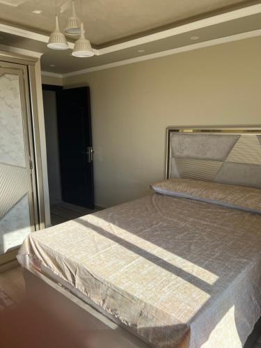 een slaapkamer met een groot bed in een kamer bij شقة فاخرة بالمنتزة فيو بحر ومنتزة in Alexandrië