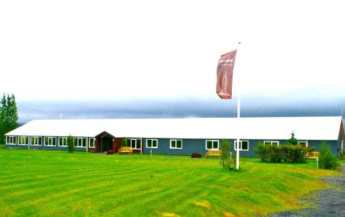 a large building with a flag in front of it at Litli Geysir Hotel in Haukadalur